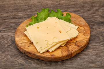 Sliced yellow cheese over board