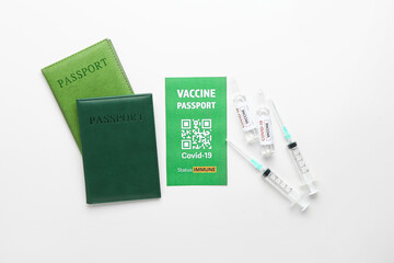 Immune passports and covid-19 vaccine on white background