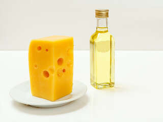 Cheese hit fitness on plate and sunflower oil on white background