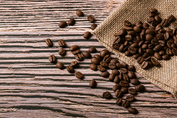 Roasted coffee beans on old wooden table