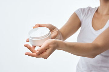 woman holding a jar of cream hand skin care dermatology therapy