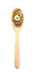 Spoon with dried chamomile flowers on white background