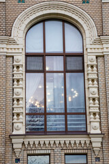 The facade of the museum building with arched windows is a former Grain Exchange, built in 1912 by the Moscow architect A.V. Ivanov in the Russian style in the city of Rybinsk, Russia