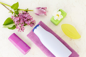 Towel and women's cosmetics on a white background.