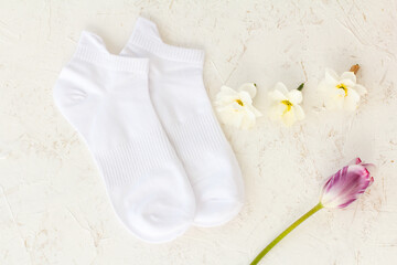 Pair of white socks on white background.