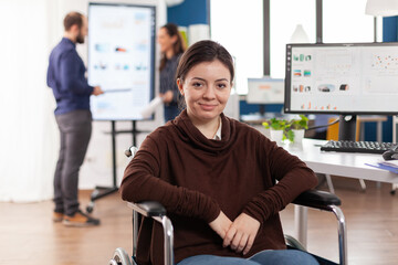 Close up of paralysed disabled invalid handicapped woman work colleague looking at camera smiling...