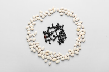 Different beans on white background. Concept of racism