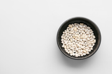 Bowl with beans on white background. Concept of racism