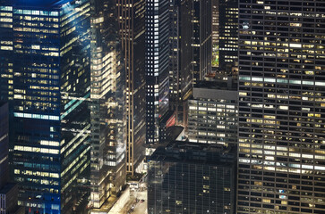 Aerial view of office buildings in Manhattan at night, New York City, USA.