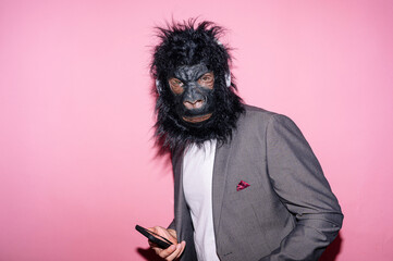 Gesture man with gorilla mask using smart phone