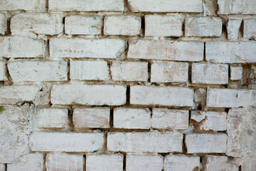 Abstract old white brick wall. background facade brick wall black and white. Vintage old brick wall texture. Grunge stone wall horizontal background. Dilapidated building facade with damaged plaster.