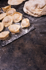 Traditional russian raw pelmeni on a metal tray.