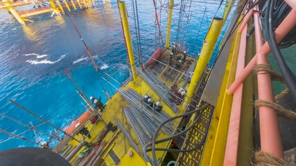 4K time lapse aerial view of erection scaffolding on the gas platform for new extension deck in the middle of the sea.