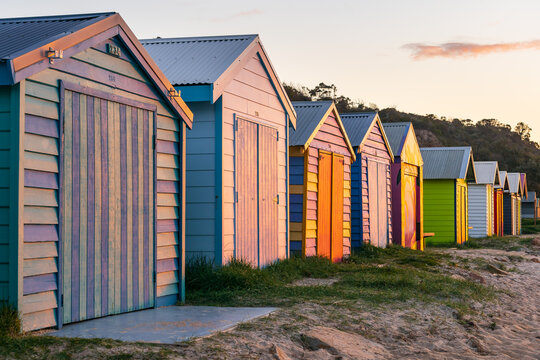 Looking along a row of colorful timber bathing boxes