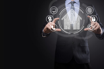 Businessman hold house icon.Smart home controlled, intelligent house, and home automation app concept.Pcb design and person with smart phone. Innovation technology internet Network Concept.