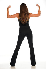 rear view of a young woman in a black shirt and trousers showing her biceps