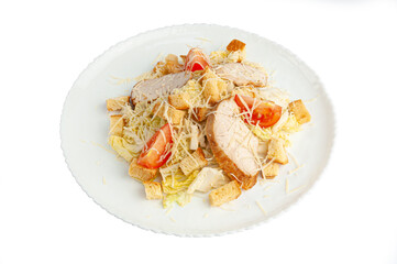 Caesar salad with Chinese cabbage. In a white plate. View from above. White background. Isolated