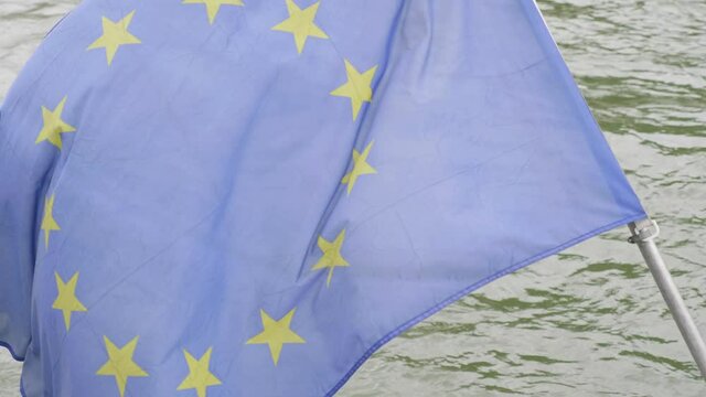 European Union flag flowing on the water background in 4k