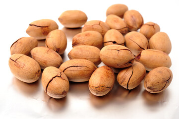 Peeled pecan nuts closeup, isolated on white background