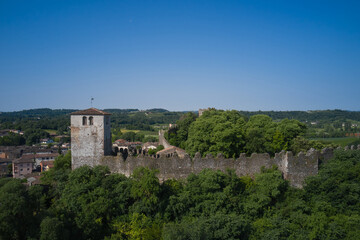 Fototapeta na wymiar Monzambano Castle, Italy. Aerial view of the Italian historic castle Castello di Monzambano on the hill. Old clock on the tower of the castle.