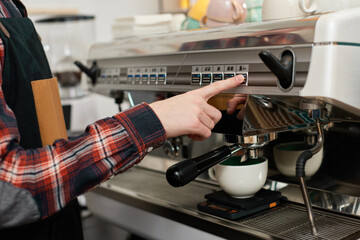 Barista using a coffee machine to make coffee