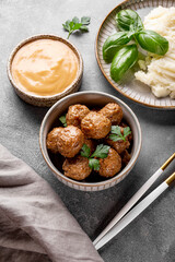  Traditional swedish meatballs with creamy sauce and mashed potatoes on gray background vertical...