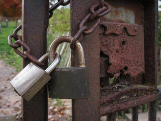 chain and padlocks on a rusty metal gate