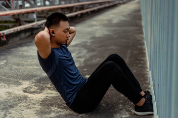 Sports and recreation concept a male adolescent doing warm-up movements as raising his body temperature and increasing blood flow to his muscles