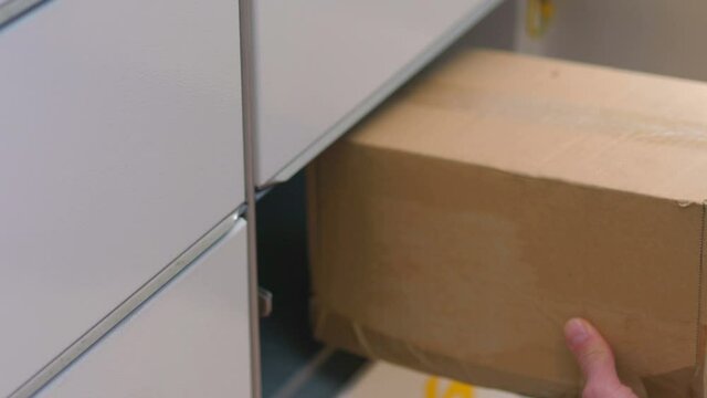 Putting a parcel to a parcel locker in 4k slow motion 60fps
