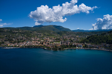 Fototapeta na wymiar Aerial view of the city of Garda, Lake Garda, Italy. Panorama on corno. Top view of the Museum of Lake Garda on the coastline. Vista lago on the coastline.