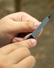 a women take care of her nails with nails tool set