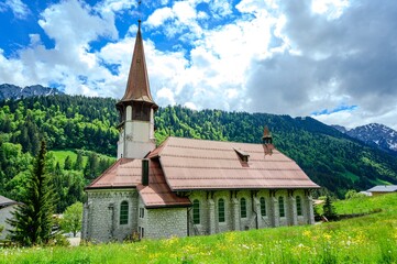 Fototapeta na wymiar Church in Jaun, alps mountains, Canton Fribourg, Freiburg nearby Bulle, Bern, Thun. Good hiking tourist way. Switzerland.