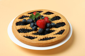 Delicious blueberry pie on beige background, close up