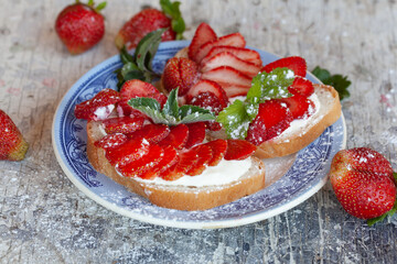 Bruschetta with strawberries on a plate