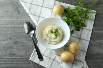 Concept of tasty eating with mashed potatoes on gray textured table