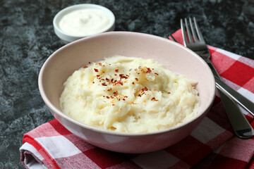 Concept of tasty eating with mashed potatoes on black smokey table