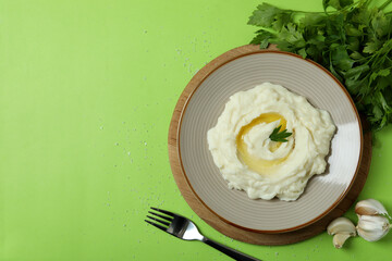 Concept of tasty eating with mashed potatoes on green background