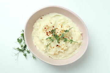 Plate of mashed potatoes on white background