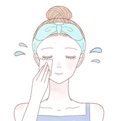 化粧水を含ませたコットンを顔に塗って保湿する女性
