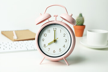 Naklejka premium Workplace concept with alarm clock on white background