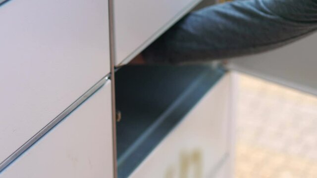 Collecting a parcel from a parcel locker in 4k slow motion 60fps