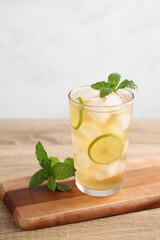 Lemon iced tea with lime on a wooden table