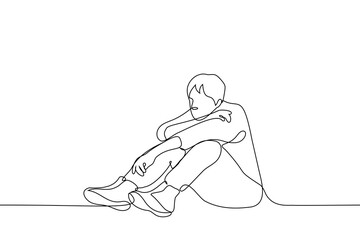 man sits on the floor or ground, his legs are bent and his head and arms are down on his knees - one line drawing. the concept of sadness, depression, fatigue, loneliness, boredom