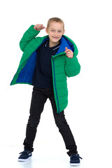 Smiling boy in unbuttoned green winter jacket