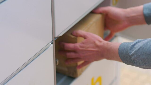 Collecting a parcel from a parcel locker in 4k slow motion 60fps