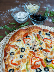 Pizza with fluffy top, tomatoes, olives, green peppers, cheese, fresh from the oven
