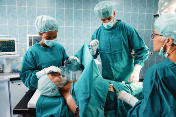 Group of surgeon team at work in operating room in hospital