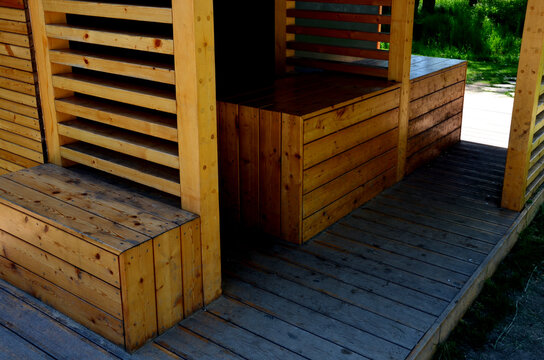 wooden bus stop with a bench and a table made of design boards lined with walls. park construction on the playground, where it is possible to repack diapers baby