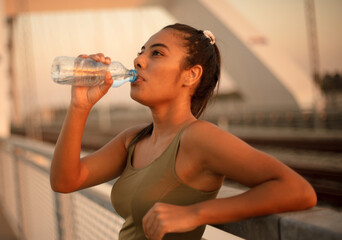 Young lady drinking water.