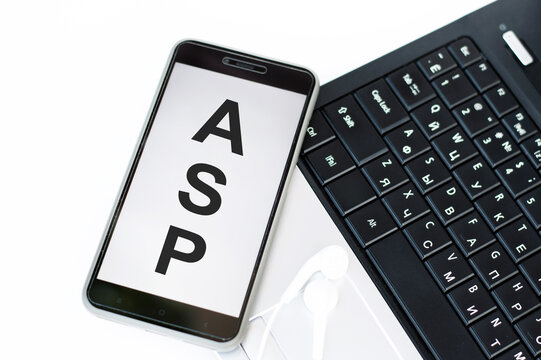 ASP or Application Service Provider text on phone screen on table near laptop, business concept
